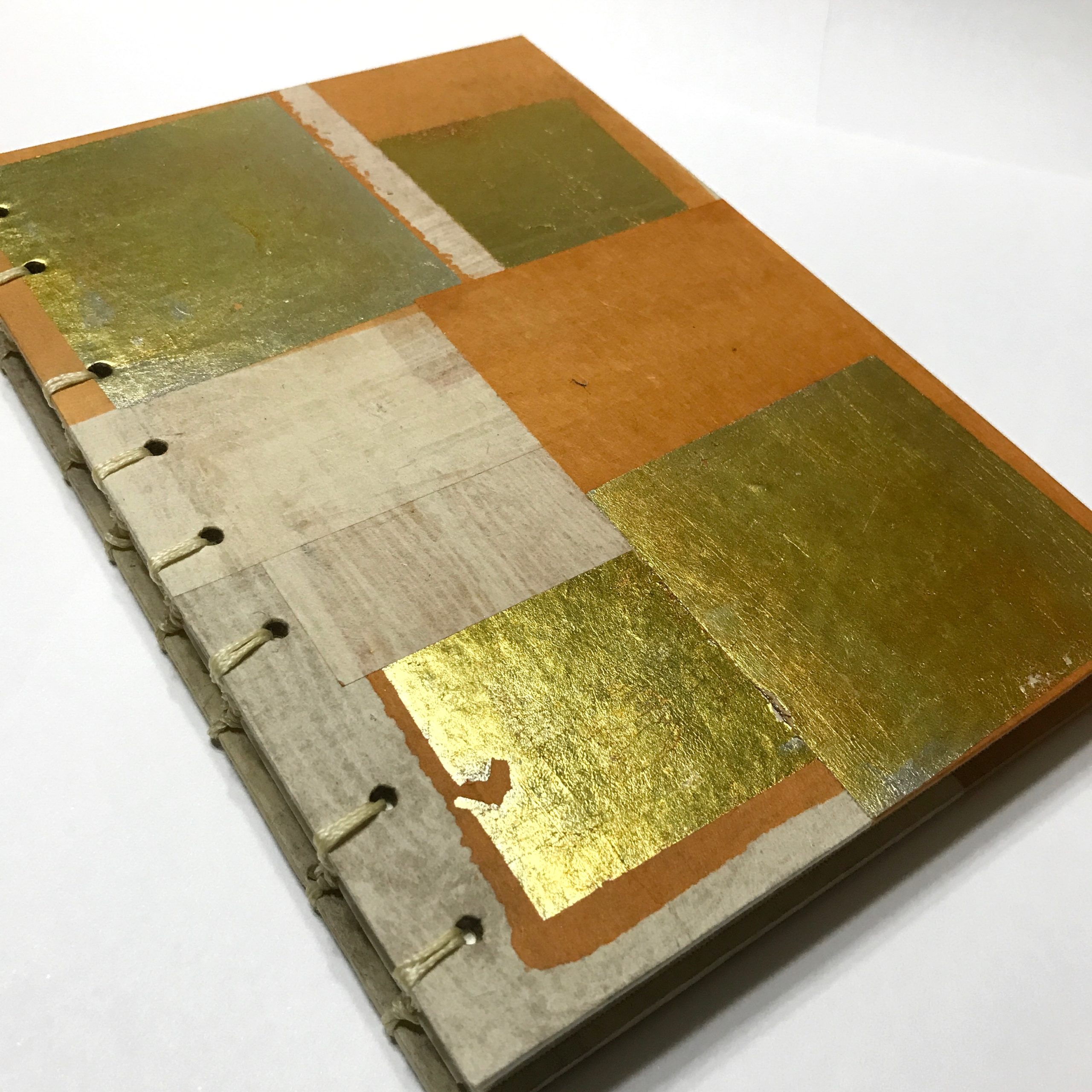 Cover of sketchbook with gold leaf and orange design