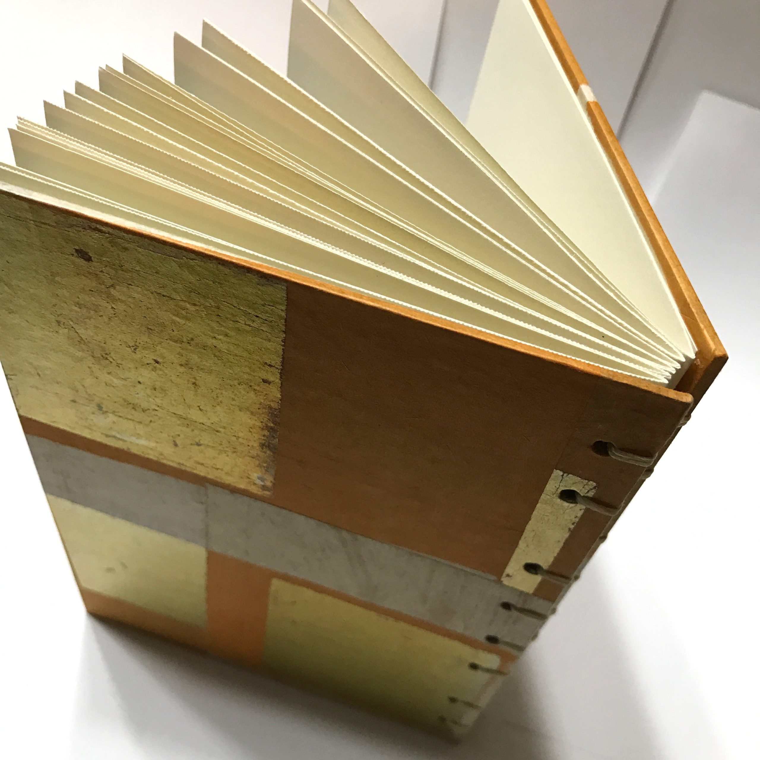 Back cove of sketchbook with gold leaf and orange design